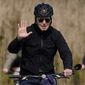 President Joe Biden waves as he rides a bicycle in Gordon&#39;s Pond State Park in Rehoboth Beach, Del., Sunday, March 20, 2022. (AP Photo/Carolyn Kaster)