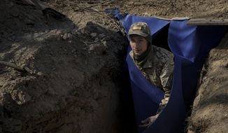 A Ukrainian serviceman exits a bunker on the outskirts of Kyiv, Ukraine, Sunday, March 20, 2022. Russian forces pushed deeper into Ukraine&#39;s besieged and battered port city of Mariupol on Saturday, where heavy fighting shut down a major steel plant and local authorities pleaded for more Western help. (AP Photo/Vadim Ghirda)