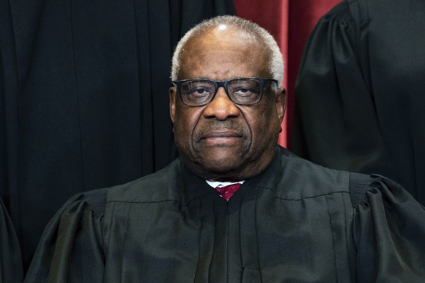 Justice Clarence Thomas sits during a group photo at the Supreme Court in Washington on Friday, April 23, 2021. (Erin Schaff/The New York Times via AP, Pool) **FILE**