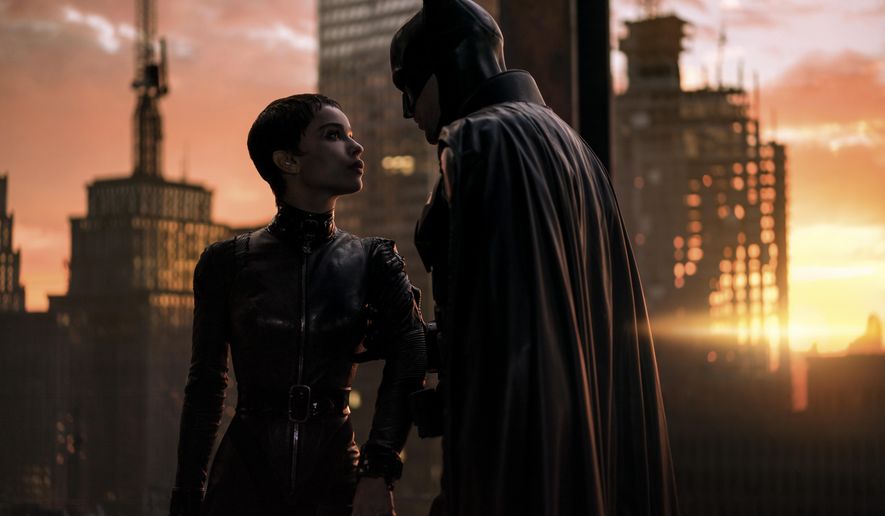 This image released by Warner Bros. Pictures shows Zoe Kravitz, left, and Robert Pattinson in a scene from &amp;quot;The Batman.&amp;quot;  “The Batman” is still going strong three weeks into its theatrical run, with a tight grip on the top spot at the box office. Robert Pattinson’s debut as the Dark Knight earned an additional $36.8 million over the weekend, according to studio estimates Sunday, March 20, 2022. It also slid past the $300 million mark ahead of projections. (Jonathan Olley/Warner Bros. Pictures via AP)