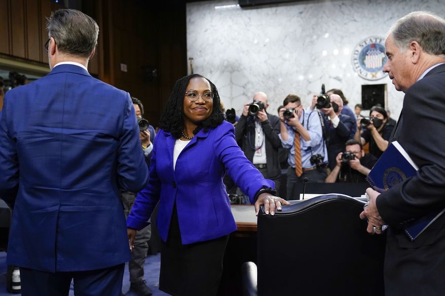 Supreme Court nominee Ketanji Brown Jackson departs with her husband Dr. Patrick Jackson, left, and former Sen. Doug Jones, D-Ala., right, after the first day of her Senate Judiciary Committee confirmation hearing on Capitol Hill in Washington, Monday, March 21, 2022. (AP Photo/J. Scott Applewhite, Pool)