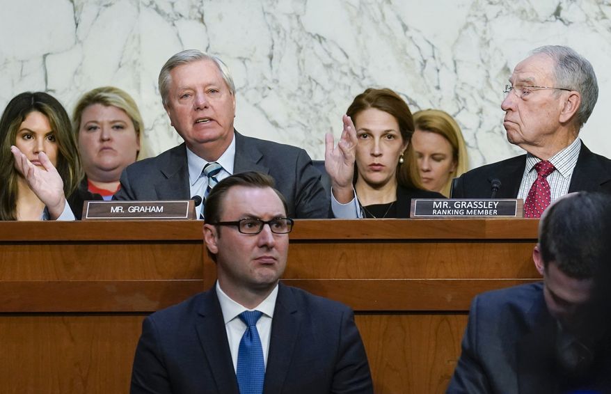 Sen. Lindsey Graham, R-S.C., left, makes an opening statement during the confirmation hearing for Supreme Court nominee Ketanji Brown Jackson, Monday, March 21, 2022, in Washington. Sen. Chuck Grassley, R-Iowa, the ranking member of the Senate Judiciary Committee, looks on at right. (AP Photo/J. Scott Applewhite, Pool)