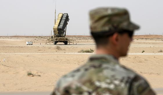 A member of the U.S. Air Force stands near a Patriot missile battery at the Prince Sultan air base in al-Kharj, central Saudi Arabia, on Feb. 20, 2020. The U.S. has transferred a significant number of Patriot antimissile interceptors to Saudi Arabia in recent weeks as the Biden administration looks to ease what has been a point of tension in the increasingly complicated U.S.-Saudi relationship. (Andrew Caballero-Reynolds/Pool via AP, File)