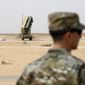 A member of the U.S. Air Force stands near a Patriot missile battery at the Prince Sultan air base in al-Kharj, central Saudi Arabia, on Feb. 20, 2020. The U.S. has transferred a significant number of Patriot antimissile interceptors to Saudi Arabia in recent weeks as the Biden administration looks to ease what has been a point of tension in the increasingly complicated U.S.-Saudi relationship. (Andrew Caballero-Reynolds/Pool via AP, File)