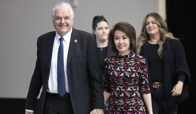 Nevada Gov. Steve Sisolak arrives with his wife, Kathy, to deliver his State of the State address at Allegiant Stadium in Las Vegas, Wednesday, Feb. 23, 2022. (Steve Marcus/Las Vegas Sun via AP, File)