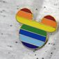 A Disney cast member displays a Mickey Mouse pin on his shirt at The Center, an LGBTQ support organization, while participating in an employee walkout of Walt Disney World, Tuesday, March 22, 2022, in Orlando, Fla. (AP Photo/Phelan M. Ebenhack) ** FILE **