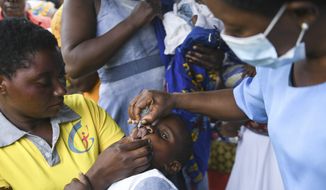 A child receives a polio vaccine, during the Malawi Polio Vaccination Campaign Launch in Lilongwe Malawi, Sunday March 20, 2022. A drive to vaccinate more than 9 million children against polio has been launched this week in four countries in southern and eastern Africa after an outbreak was confirmed in Malawi. (AP Photo/Thoko Chikondi)