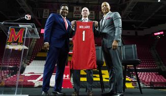 Kevin Willard, center, poses with Maryland University president Darryll Pines, left, and athletic director Damon Evans during a news conference announcing Willard as the new head coach of the Maryland men&#x27;s NCAA college basketball team, Tuesday, March 22, 2022, in College Park, Md. (AP Photo/Julio Cortez)