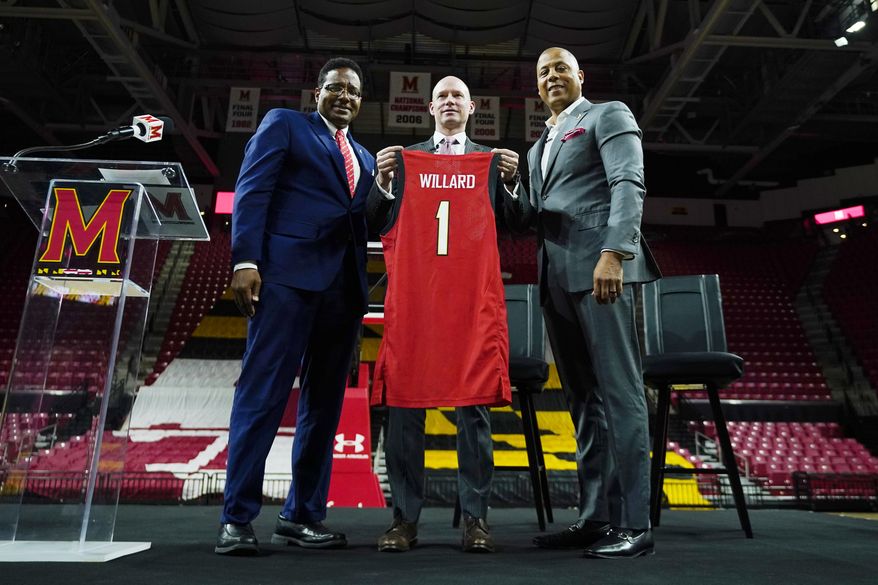 Kevin Willard, center, poses with Maryland University president Darryll Pines, left, and athletic director Damon Evans during a news conference announcing Willard as the new head coach of the Maryland men&#39;s NCAA college basketball team, Tuesday, March 22, 2022, in College Park, Md. (AP Photo/Julio Cortez)