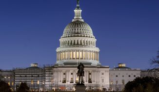 The U.S. Capitol building is seen before sunrise on Capitol Hill in Washington, Monday, March. 21, 2022. (AP Photo/Gemunu Amarasinghe, File)