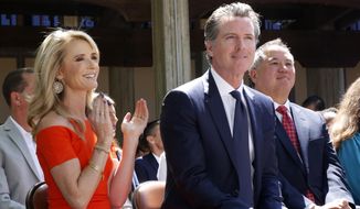 California first partner Jennifer Siebel Newsom, left, attends a signing ceremony with her husband, Gov. Gavin Newsom, next to her, at Sacramento City College in Sacramento, Calif., on July 1, 2019. Gov. Newsom and his wife earned nearly $1.5 million in 2020 and paid about $480,000 in taxes, down from $1.7 million the couple reported in 2019, his first year as governor. In addition to his salary as governor, Newsom&#39;s income comes from a winery and restaurant business that he put in a blind trust when he became governor. His wife, Jennifer Siebel Newsom, is a documentary filmmaker. (AP Photo/Rich Pedroncelli, File)