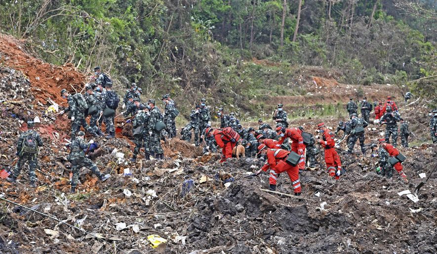 In this photo released by Xinhua News Agency, rescue workers search for the black boxes at a plane crash site in Tengxian county, southwestern China&#39;s Guangxi Zhuang Autonomous Region, Tuesday, March 22, 2022. A China Eastern flight 5735 carrying 123 passengers and nine crew members crashed outside the city of Wuzhou in the Guangxi region while flying from Kunming, the capital of the southwestern province of Yunnan, to Guangzhou, an industrial center not far from Hong Kong on China&#39;s southeastern coast. It ignited a fire big enough to be seen on NASA satellite images before firefighters could extinguished it. (Zhou Hua/Xinhua via AP)