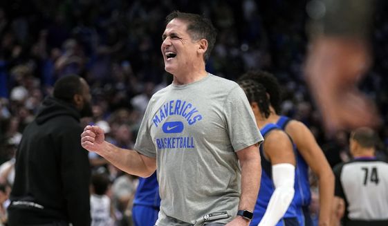 Dallas Mavericks team owner Mark Cuban celebrates on the court during a time out after the Mavericks took the lead in the second half of an NBA basketball game against the Sacramento Kings in Dallas, Saturday, March, 5, 2022. (AP Photo/Tony Gutierrez, File)