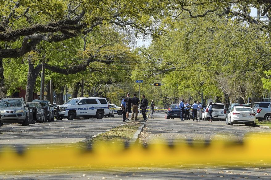 Members of the New Orleans Police Department investigate a carjacking scene on Bienville Street that resulted in a woman's death in New Orleans, La., Monday, March 21, 2022. (Max Becherer/The Times-Picayune/The New Orleans Advocate via AP)