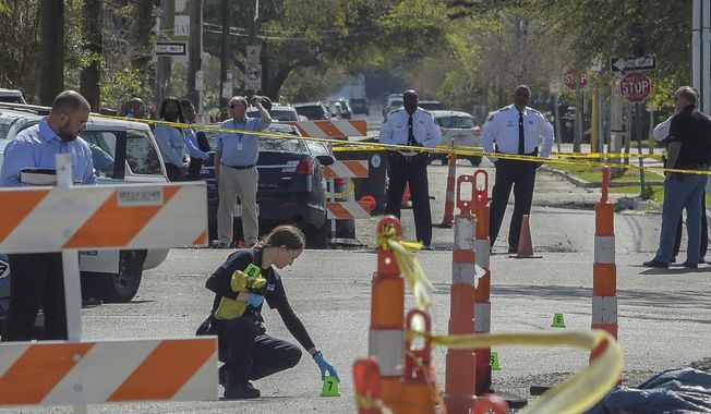 Members of the New Orleans Police Department investigate a carjacking scene on N. Pierce St. that resulted in an elderly woman&#x27;s death in New Orleans, La., Monday, March 21, 2022. (Max Becherer/The Times-Picayune/The New Orleans Advocate via AP)