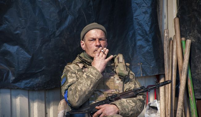 Ukrainian serviceman has a rest on his position in Kharkiv, Ukraine, Tuesday, March 22, 2022. (AP Photo/Andrew Marienko)