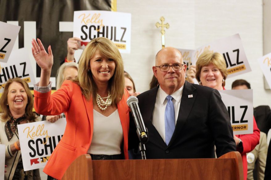 Kelly Schulz, who is seeking the Republican nomination for governor of Maryland, waves after receiving the endorsement of Gov. Larry Hogan, right, who is term limited, on Tuesday, March 22, 2022, in Annapolis, Md. (AP Photo/Brian Witte)
