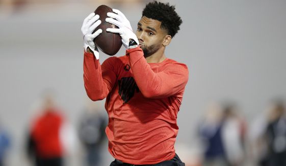 Wide receiver Chris Olave runs a football drill during Ohio State Pro Day in Columbus, Ohio, Wednesday, March 23, 2022. (AP Photo/Paul Vernon)