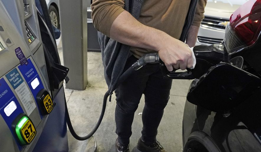 A customer pumps gasoline into his car at a Sam&#39;s Club fuel island in Gulfport, Miss., Feb. 19, 2022. The Russia-Ukraine crisis is helping to raise oil and gasoline prices to high levels. (AP Photo/Rogelio V. Solis) ** FILE **
