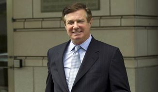 In this May 23, 2018, photo, Paul Manafort, President Donald Trump&#39;s former campaign chairman, leaves the Federal District Court after a hearing in Washington. Manafort was removed from a plane at Miami International Airport before it took off for Dubai because he carried a revoked passport. Miami-Dade police confirmed Wednesday, March 23, 2022, that Manafort was removed from the Emirates Airline flight without incident on Sunday night. (AP Photo/Jose Luis Magana)