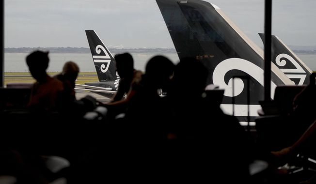Passengers wait in the Air New Zealand lounge at Auckland International Airport in Auckland, New Zealand, Wednesday, March 23, 2022. New Zealand&#x27;s flagship airline said Wednesday it plans to start direct flights to New York in September, a route that would take more than 17 hours southbound and be among the longest nonstop flights in the world. (AP Photo/Mark Baker)