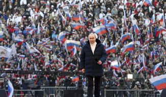 Russian President Vladimir Putin arrives to deliver his speech at the concert marking the eighth anniversary of the referendum on the state status of Crimea and Sevastopol and its reunification with Russia, in Moscow, Russia, Friday, March 18, 2022. (Mikhail Klimentyev, Sputnik, Kremlin Pool Photo via AP)