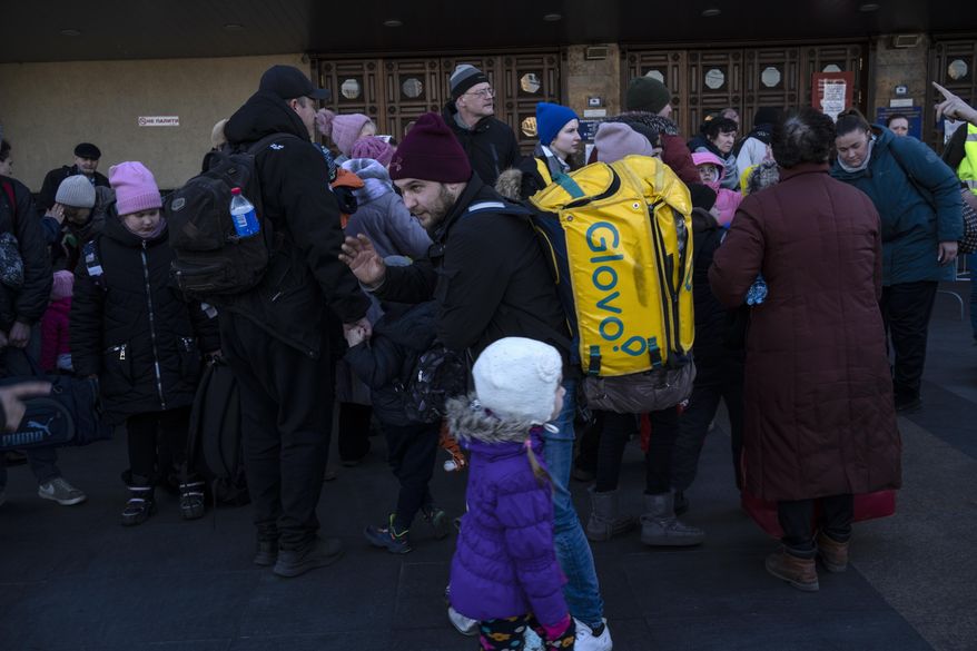 Families arrive at Kyiv&#x27;s train station after leaving their homes in Chernihiv, Ukraine, through a humanitarian corridor, Monday, March 21, 2022. (AP Photo/Rodrigo Abd)