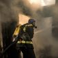 A Ukrainian firefighter sprays water in the ruins of a house destroyed by bombing in Kyiv, Ukraine, Wednesday, March 23, 2022. The Kyiv city administration says Russian forces shelled the Ukrainian capital overnight and early Wednesday morning, in the districts of Sviatoshynskyi and Shevchenkivskyi, damaging buildings. (AP Photo/Vadim Ghirda)