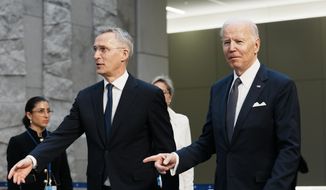 U.S. President Joe Biden, right, walks with NATO Secretary-General Jens Stoltenberg prior to a group photo during an extraordinary NATO summit at NATO headquarters in Brussels, Thursday, March 24, 2022. As the war in Ukraine grinds into a second month, President Joe Biden and Western allies are gathering to chart a path to ramp up pressure on Russian President Vladimir Putin while tending to the economic and security fallout that&#39;s spreading across Europe and the world. (AP Photo/Thibault Camus)