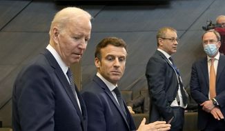 U.S. President Joe Biden, left, speaks with French President Emmanuel Macron during a round table meeting during an extraordinary NATO summit at NATO headquarters in Brussels, Thursday, March 24, 2022. As the war in Ukraine grinds into a second month, President Joe Biden and Western allies are gathering to chart a path to ramp up pressure on Russian President Vladimir Putin while tending to the economic and security fallout that&#x27;s spreading across Europe and the world. (AP Photo/Markus Schreiber)