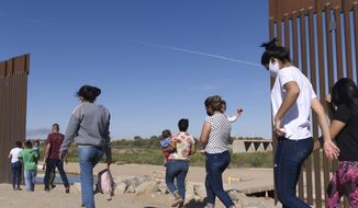 A group of Brazilian migrants make their way around a gap in the U.S.-Mexico border in Yuma, Ariz., seeking asylum in the United States after crossing over from Mexico, June 8, 2021. border. The Biden administration has unveiled new procedures to handle asylum claims at the U.S. southern border, hoping to decide cases in months instead of years. The rules empower asylum officers to grant or deny claims, an authority that has been limited to immigration judges for people arriving at the border with Mexico.  (AP Photo/Eugene Garcia) **FILE**