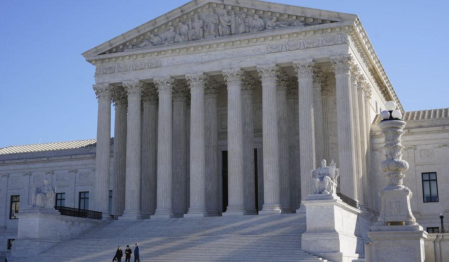 FILE - Visitors walk outside the Supreme Court building on Capitol Hill in Washington, Feb. 21, 2022. (AP Photo/Patrick Semansky, File)