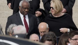 Supreme Court Associate Justice Clarence Thomas, left and his wife Virginia Thomas, right, leave the Basilica of the National Shrine of the Immaculate Conception in Washington after attending funeral services of the late Supreme Court Associate Justice Antonin Scalia, on Feb. 20, 2016. Virginia Thomas sent weeks of text messages imploring White House Chief of Staff Mark Meadows to act to overturn the 2020 presidential election furthering then-President Donald Trump&#39;s lies that the free and fair vote was marred by nonexistent fraud, according to copies of the messages obtained by The Washington Post and CBS News. (AP Photo/Pablo Martinez Monsivais, File)