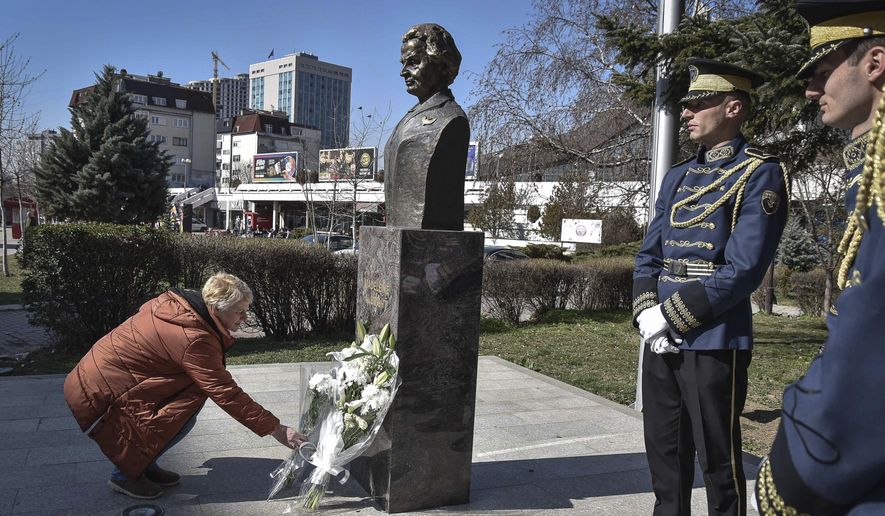A woman lays a bouquet of flowers at the foot of a statue of former U.S. Secretary of State Madeleine Albright, in Pristina, Kosovo, Thursday, March 24, 2022. A monument in Kosovo, a snake named after her in Serbia. Madeleine Albright was either loved or hated in the Balkans for her pivotal role during the southern European region&#39;s wars of the 1990s. Following the former U.S. secretary of state&#39;s death on Wednesday at age 84, how her legacy is viewed from the Balkans mostly depends on whether one was on the receiving or triggering end of the bloody breakup of the former Yugoslavia. (AP Photo/Visar Kryeziu)