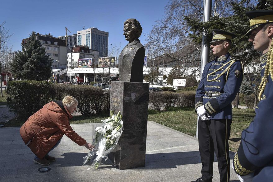 A woman lays a bouquet of flowers at the foot of a statue of former U.S. Secretary of State Madeleine Albright, in Pristina, Kosovo, Thursday, March 24, 2022. A monument in Kosovo, a snake named after her in Serbia. Madeleine Albright was either loved or hated in the Balkans for her pivotal role during the southern European region&#39;s wars of the 1990s. Following the former U.S. secretary of state&#39;s death on Wednesday at age 84, how her legacy is viewed from the Balkans mostly depends on whether one was on the receiving or triggering end of the bloody breakup of the former Yugoslavia. (AP Photo/Visar Kryeziu)