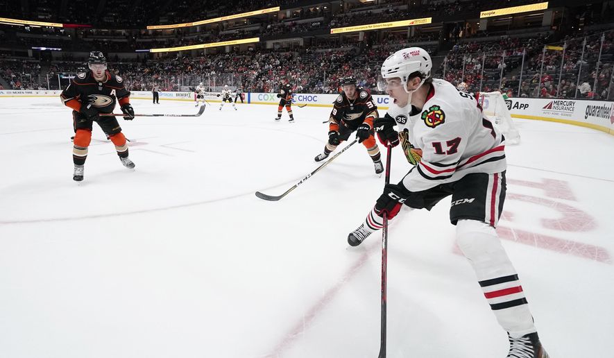 Chicago Blackhawks center Dylan Strome, right, tries to get the puck by Anaheim Ducks defenseman Cam Fowler, left, and center Sam Carrick during the third period of an NHL hockey game Wednesday, March 23, 2022, in Anaheim, Calif. (AP Photo/Mark J. Terrill) **FILE**