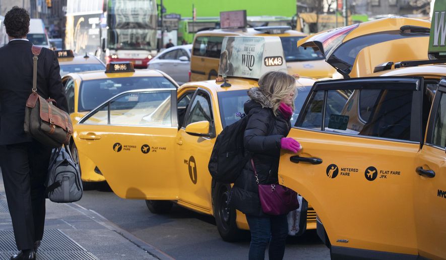 A passenger gets into a taxi, Wednesday, Jan. 29, 2020, in New York. (AP Photo/Mark Lennihan, File)