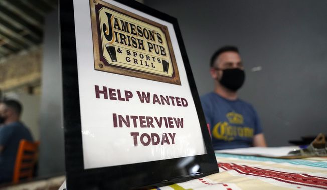 A hiring sign is shown at a booth for Jameson&#x27;s Irish Pub during a job fair on Sept. 22, 2021, in the West Hollywood section of Los Angeles. California&#x27;s unemployment rate has fallen to 5.4% after employers added a surprising 138,100 jobs in February. (AP Photo/Marcio Jose Sanchez, File)