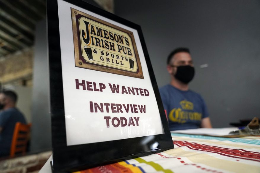 A hiring sign is shown at a booth for Jameson&#x27;s Irish Pub during a job fair on Sept. 22, 2021, in the West Hollywood section of Los Angeles. California&#x27;s unemployment rate has fallen to 5.4% after employers added a surprising 138,100 jobs in February. (AP Photo/Marcio Jose Sanchez, File)