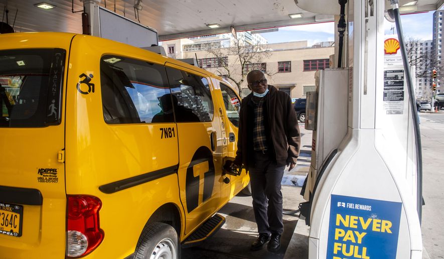 Taxi driver Marc Dussuau fuels his cab at the Shell gas station on Friday, March 25, 2022, in New York. With fuel prices approaching $5 a gallon at some New York City gas stations, drivers for Uber and Lyft and the city&#39;s taxi fleets are demanding rate surcharges to help offset the rising cost of keeping cars on the road.  (AP Photo/Brittainy Newman) **FILE**