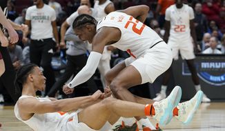 Miami&#39;s Isaiah Wong is conratulated by Kameron McGusty (23) after making a shot and being fouled during the second half of a college basketball game in the Sweet 16 round of the NCAA tournament Friday, March 25, 2022, in Chicago. (AP Photo/Nam Y. Huh)