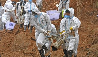 FILE - In this photo released by Xinhua News Agency, rescuers carry a piece of plane wreckage at the site of Monday&#x27;s plane crash in Tengxian County, southern China&#x27;s Guangxi Zhuang Autonomous Region, on March 25, 2022. The second “black box” has been recovered following the crash of a China Eastern Boeing 737-800 that killed 123 people last week, Chinese state media said Sunday, March 27. (Zhou Hua/Xinhua via AP, File)