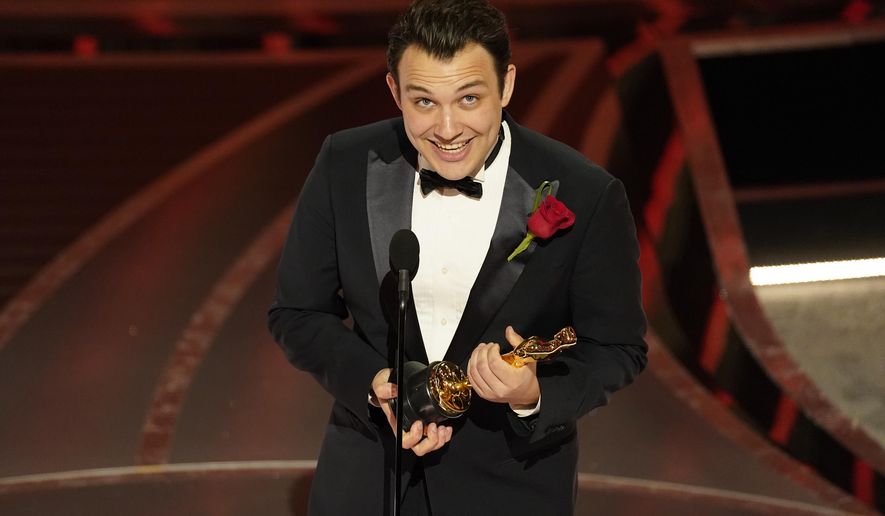 Ben Proudfoot accepts the award for best documentary short subject for "The Queen of Basketball" at the Oscars on Sunday, March 27, 2022, at the Dolby Theatre in Los Angeles. (AP Photo/Chris Pizzello)