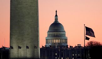 The U.S. Capitol building, center, is seen next to the bottom part of the Washington Monument, left, before sunrise on Capitol Hill in Washington, Thursday, Dec. 19, 2019. (AP Photo/Julio Cortez) ** FILE **