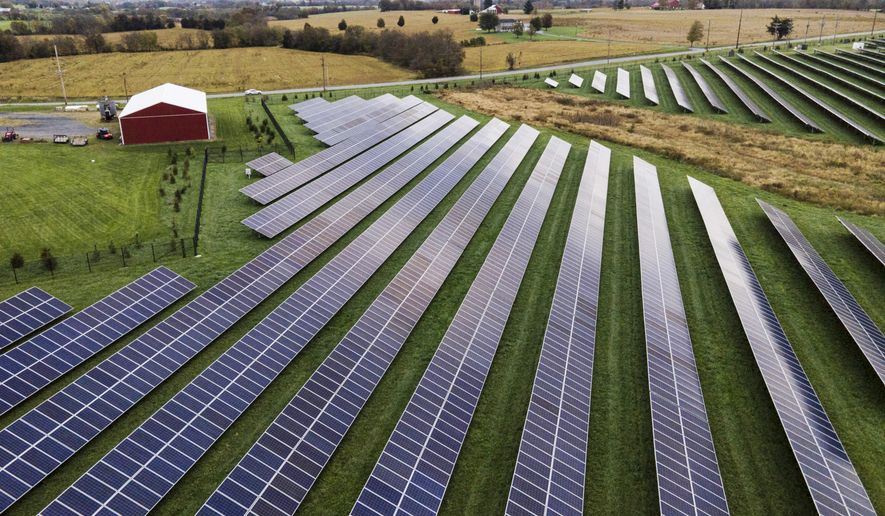 Farmland is seen with solar panels from Cypress Creek Renewables, Oct. 28, 2021, in Thurmont, Md. President Biden's proposed budget for fiscal 2023 includes billions of dollars to tackle climate change, the transition to clean energy and environmental justice, in addition to more than $11 billion in foreign assistance to aid developing countries adapt to a warming planet. (AP Photo/Julio Cortez, File)