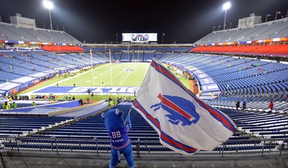 FILE - Buffalo Bills fans leave Bills Stadium as a mascot waves a flag after an NFL divisional round football game against the Baltimore Ravens, Jan. 16, 2021, in Orchard Park, N.Y. State and county taxpayers will be asked to commit $850 million in public funds toward construction of the Buffalo Bills&#39; new stadium, which has a state-projected price tag of $1.35 billion, a person familiar with the the plan told The Associated Press on Monday, March 28, 2022. (AP Photo/Adrian Kraus, File)