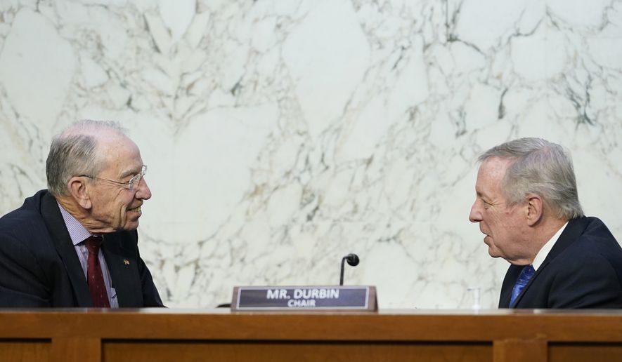 Senate Judiciary Committee Chairman Sen. Dick Durbin, D-Ill., right, talks with Sen. Chuck Grassley, R-Iowa, ranking member, left, before the start of a committee business meeting on Capitol Hill in Washington, Monday, March 28, 2022, regarding Supreme Court nominee Judge Ketanji Brown Jackson. (AP Photo/Susan Walsh)