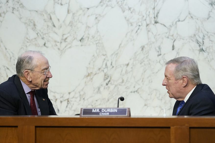 Senate Judiciary Committee Chairman Sen. Dick Durbin, D-Ill., right, talks with Sen. Chuck Grassley, R-Iowa, ranking member, left, before the start of a committee business meeting on Capitol Hill in Washington, Monday, March 28, 2022, regarding Supreme Court nominee Judge Ketanji Brown Jackson. (AP Photo/Susan Walsh)