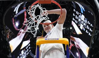 Kansas&#39; Mitch Lightfoot cuts down the net after a college basketball game in the Elite 8 round of the NCAA tournament Sunday, March 27, 2022, in Chicago. Kansas won 76-50 to advance to the Final Four. (AP Photo/Nam Y. Huh) **FILE**