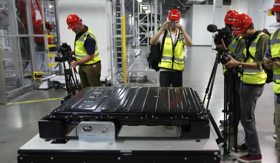 FILE - A Tesla battery pack is displayed during a media tour of the new Tesla Motors Inc., Gigafactory Tuesday, July 26, 2016, in Sparks, Nev. Interest in lithium has exploded in recent years because of its use in rechargeable batteries for electric and hybrid cars, lawnmowers, power tools and more. Lithium batteries also power laptops and cell phones. (AP Photo/Rich Pedroncelli, File)